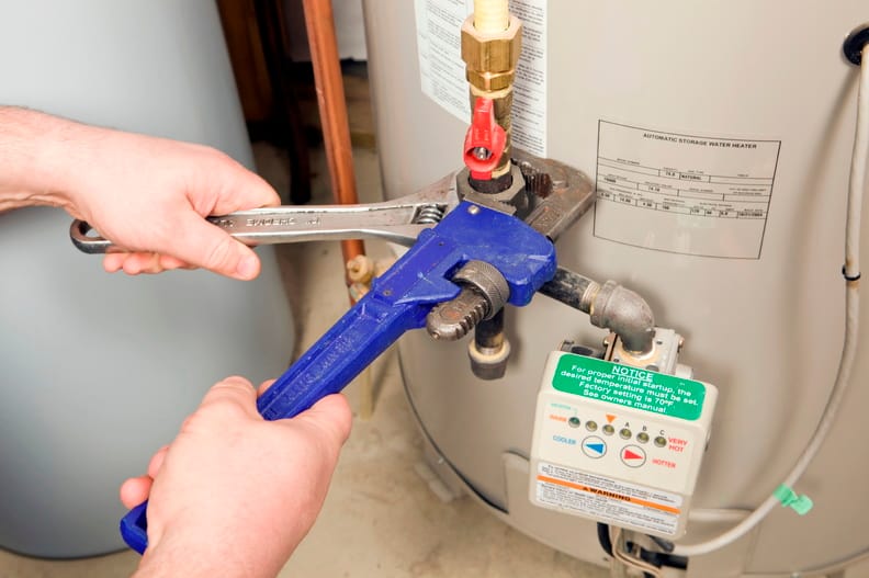 Plumber repairing a water heater valve in Suwanee